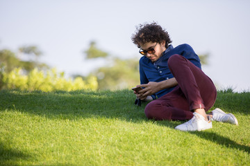 checking phone in the garden