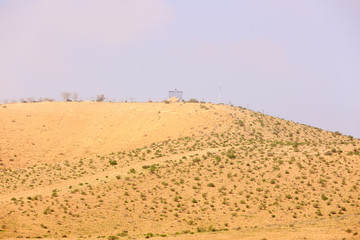 Hill in desert with Chanukiah under sky