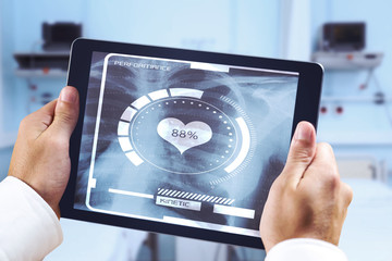 Man using tablet pc against sterile bedroom