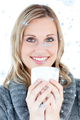 Smiling woman drinking a hot coffee against a white background against snow falling