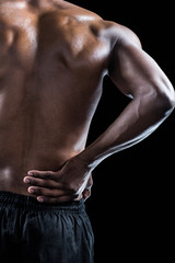 Fototapeta na wymiar Cropped image of muscular athlete suffering through back pain