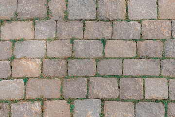 The road is paved with a paving stone