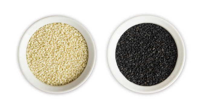 Black and white sesame on white background. Top view. Black and white sesame in a bowl isolated on white background. Sesame with copy space for text.