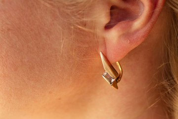 ear of a happy woman with a beautiful earring