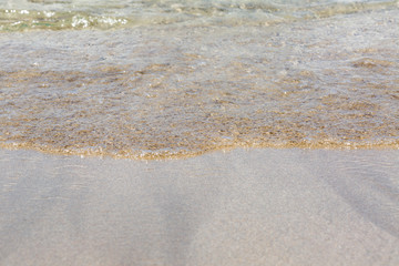 Fototapeta na wymiar Soft wave of the sea on the sandy beach