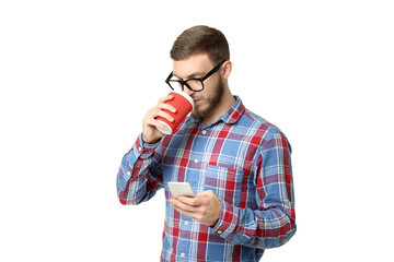 Young man with smartphone and cup of coffee on white background