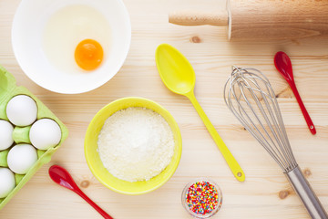 Ingredients for baking on the wooden background. Сookery, food, confectionery and home kitchen concept. Top view. Close up.