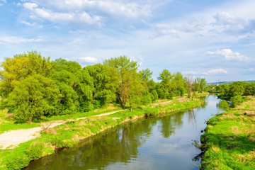 View of Vistula river and green fields near Tyniec village in springtime, Poland