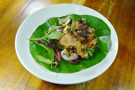 Thai spicy slice roasted pork salad on banana leaf