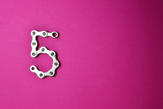 bike chain number five on pink background