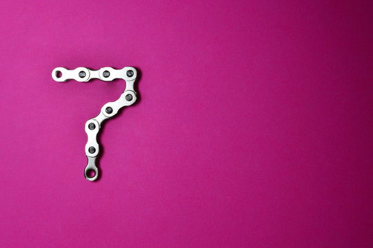 bike chain number seven on pink background