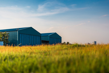 Modern new company warehouse building, farm buildings by the field, outdoors theme concept vintage...