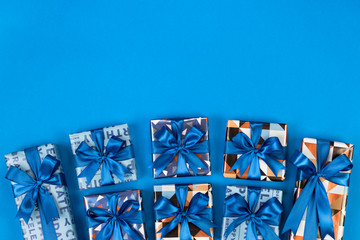 Gift boxes composition on blue background. Flat lay text space.