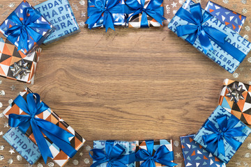 Gift boxes composition on wooden table. Flat lay text space.