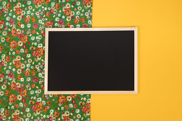 Empty chalkboard on yellow background with copy space.