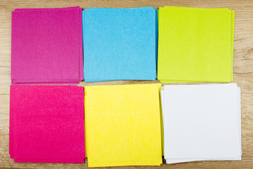 Fototapeta premium Сolorful paper blanks, Office concept. Empty space for design and text, wooden background