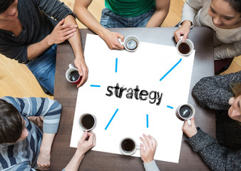 The word strategy on page with people sitting around table drinking coffee