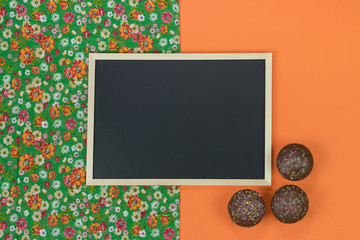 Empty chalkboard on orange background with copy space.
