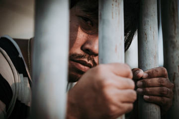 Hands of men desperate to catch the iron prison,prisoner concept,thailand people,Hope to be free,A...