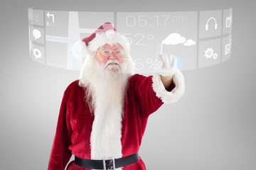 Santa Claus points at something against grey vignette