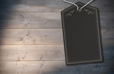Elegant dark grey tag against bleached wooden planks background