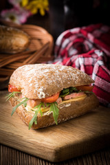 Triangular sandwich with cheese, ham and tomato.