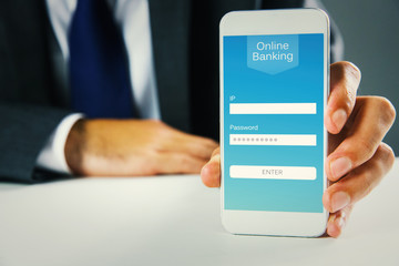 Businessman using smartphone against online banking
