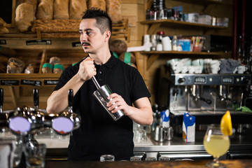 Male barista making cocktails