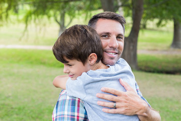 Father and son hugging in the park