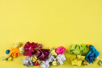 Crumpled Color paper balls. Empty space for text and design. Yellow background