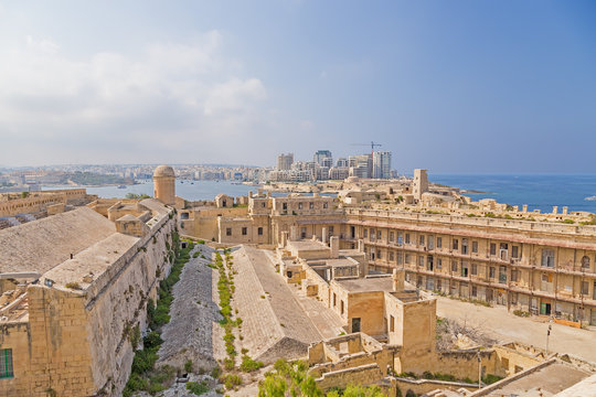 Valletta, Malta. Fort St. Elmo. In the background, on the other side of the bay of Marsamxett, Fort Tigne and the town of Sliema