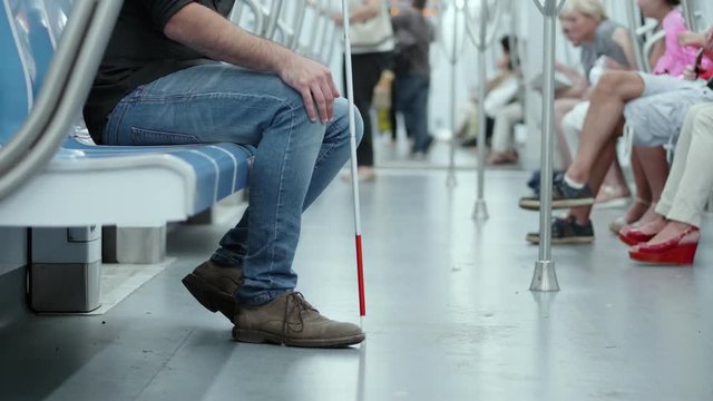  blind man in metro wagon- disability, handicap, autonomy