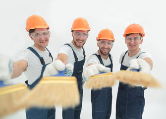 smiling group of builders with a paint brush