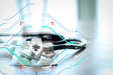 Studio macro of a stethoscope and pills with shallow DOF evenly matched abstract on wood table background copy space