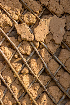 The wall of the old house in a Russian village smeared with clay
