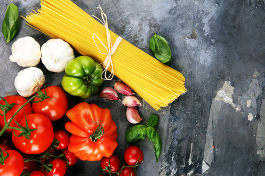 Italian food background with pasta, basil and tomato, health or vegetarian concept.