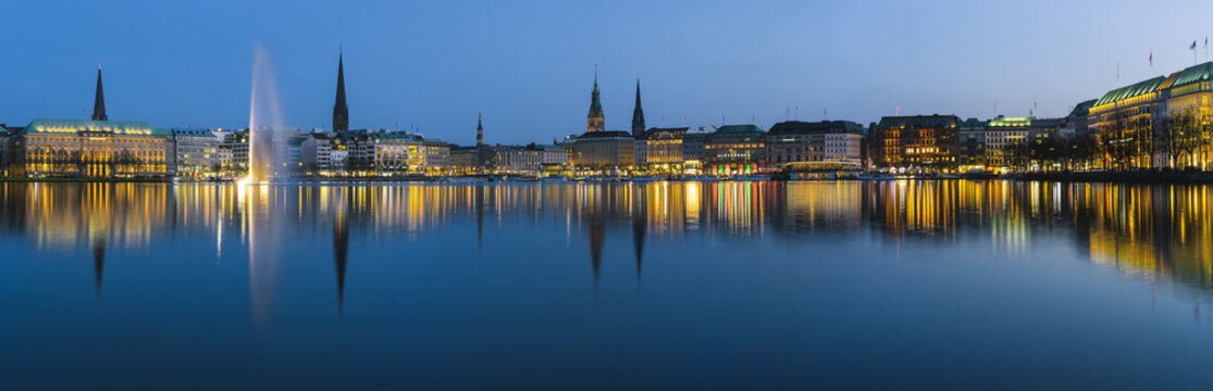 Beautiful panoramic view of Hamburg town hall - Rathaus and Alster river at spring earning evening during blue hour
