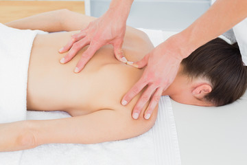 Physiotherapist massaging womans back