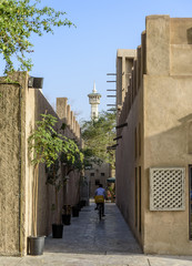 Fototapeta na wymiar Ancient streets of Bastakiya, Dubai, with a mosque minaret at the end of the street. UAE 