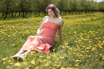 Fototapeta na wymiar Meadow, Young beautiful pregnant woman