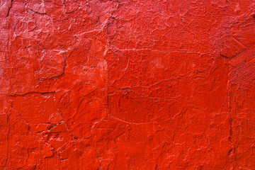 Old wall painted in bright red paint
