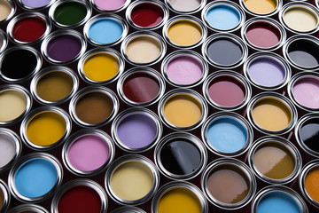 Buckets full of rainbow colored oil paint