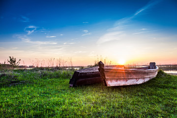 Wooden boats on the background of the lake during the sunset