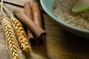 Close-up of wheat barley and cinnamon sticks