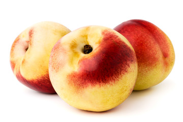 Three ripe nectarines on a white. isolated.