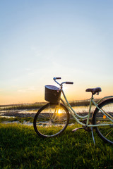 Fototapeta na wymiar Bike on the shore of the lake at sunset