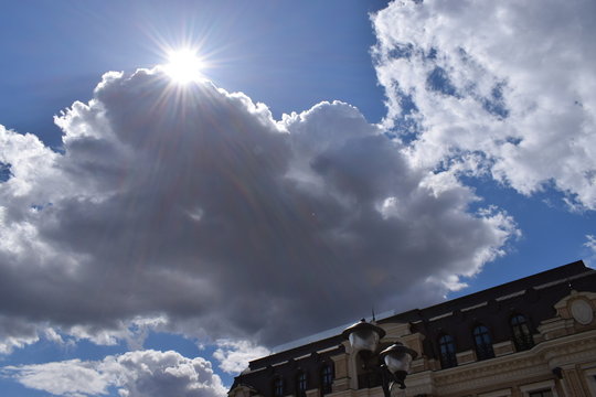 Sun Rays Coming Out Of The Clouds In The Sky Cityscape