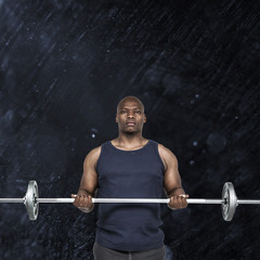 Fototapeta na wymiar Fit man lifting heavy barbell against black background