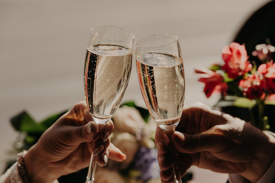 Champagne glasses during toast at party. Romantic dinner or date with champagne glasses. Newlyweds have celebrate wedding party. Marriage concept