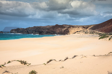 A view of Playa de Las Conchas, a beautiful beach on La Graciosa, a small island near Lanzarote, Canary Islands, in the middle of the Atlantic Ocean.